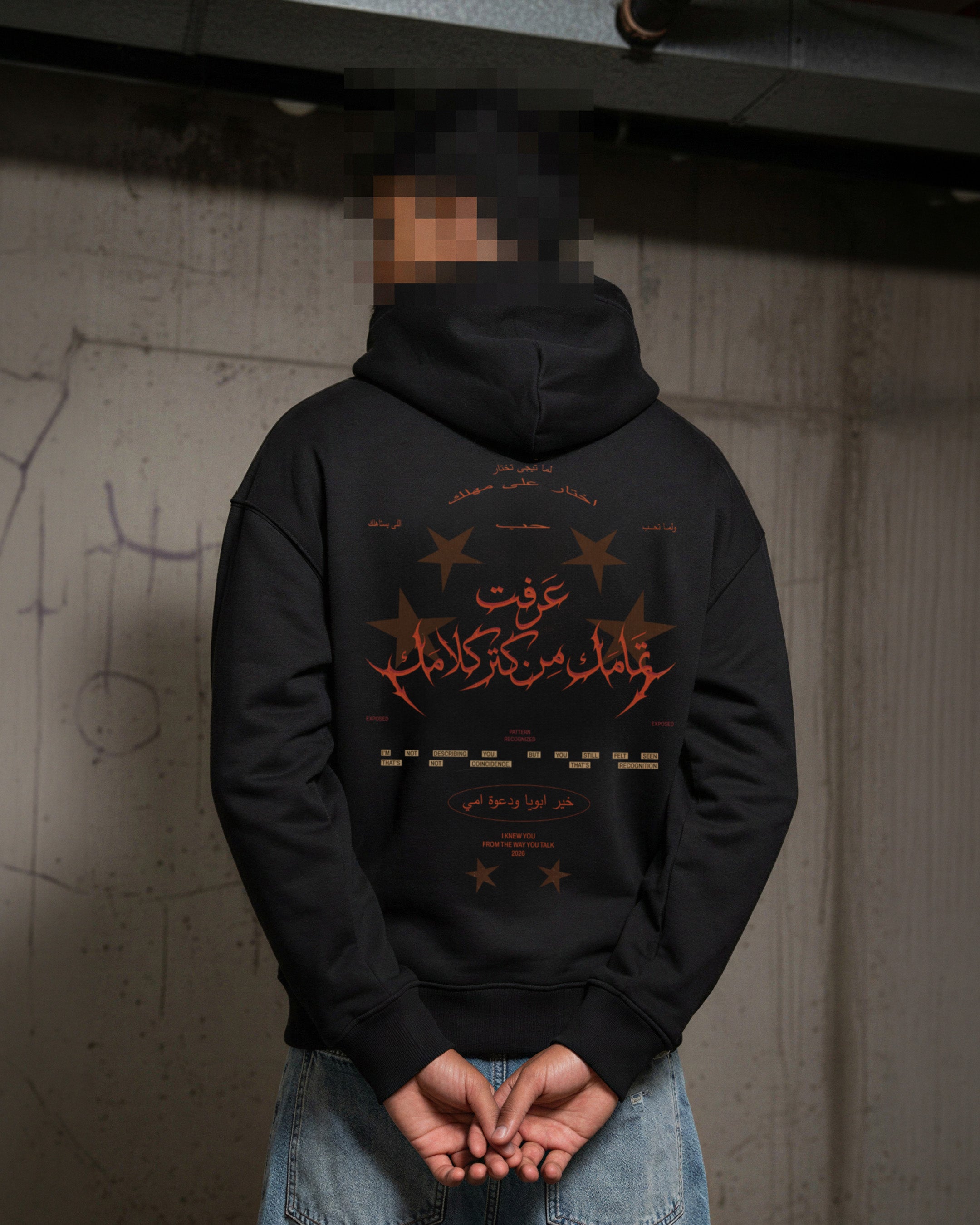 All Talk Hoodie in black, model back view with Arabic graphic