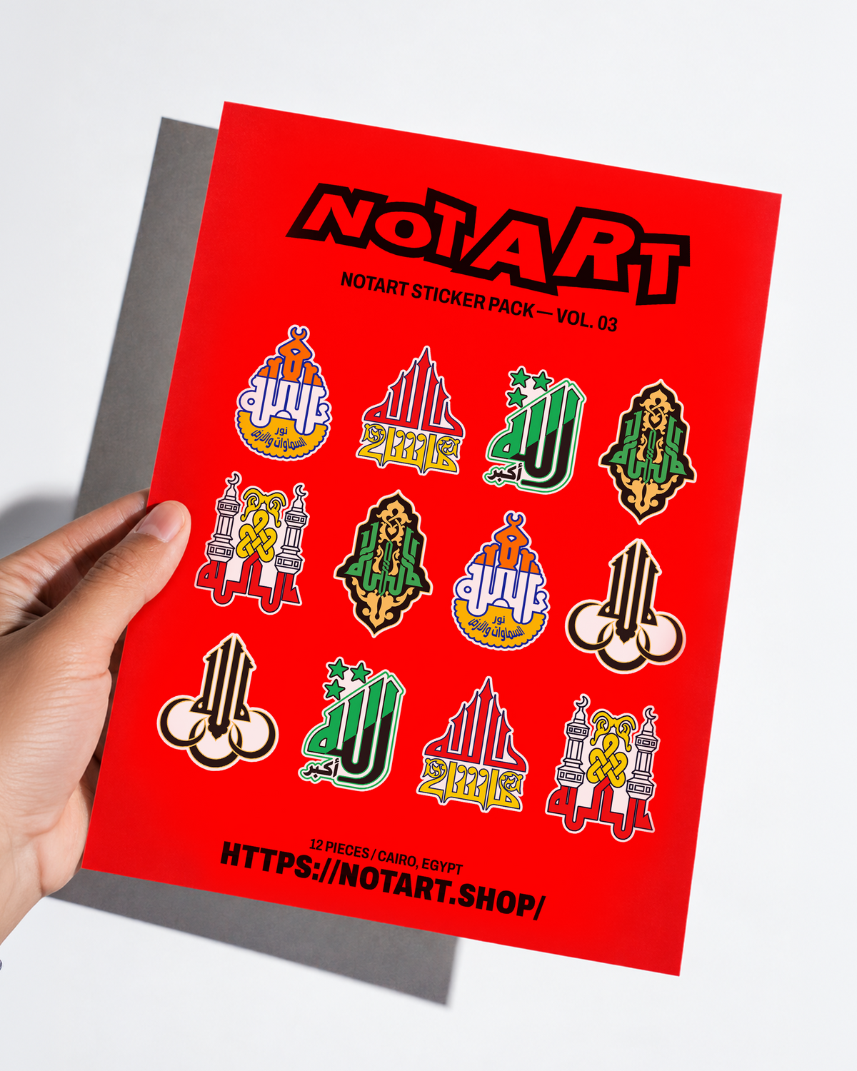 Hand holding NOTART Sticker Pack Vol. 03 with two red A4 sticker sheets